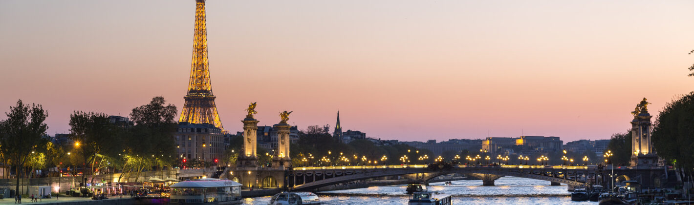 Paris, traffic on the Seine river at sunset, with Eiffel tower in background